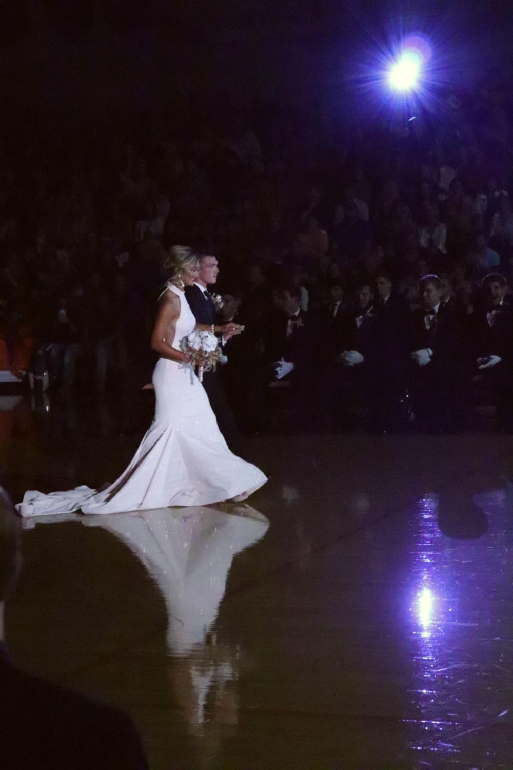 Senior, Joely Winn being escorted by Johnathan Yancy.