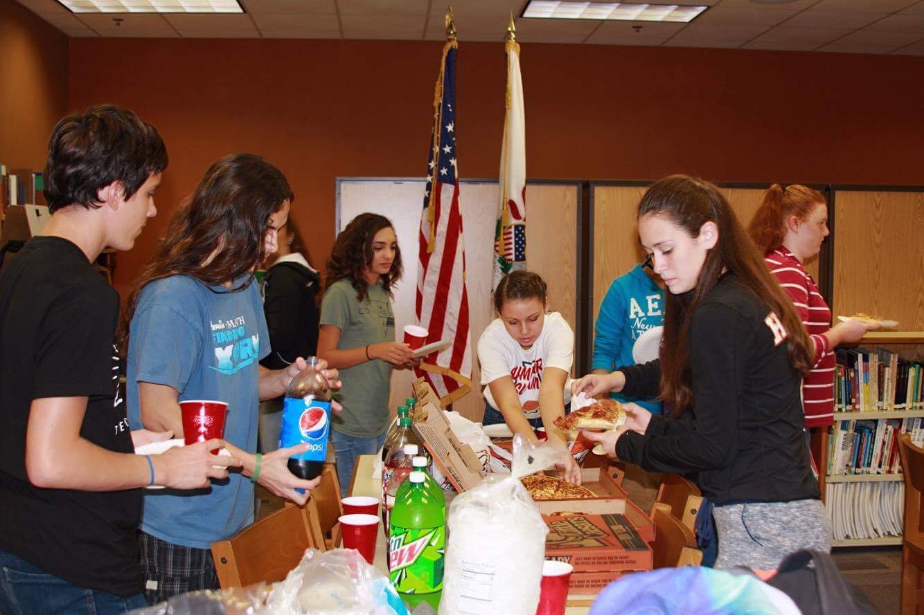 Spending some time in fellowship with one another and enjoying pizza club members discuss the upcoming year. Photo Credit; Grace Hosmon