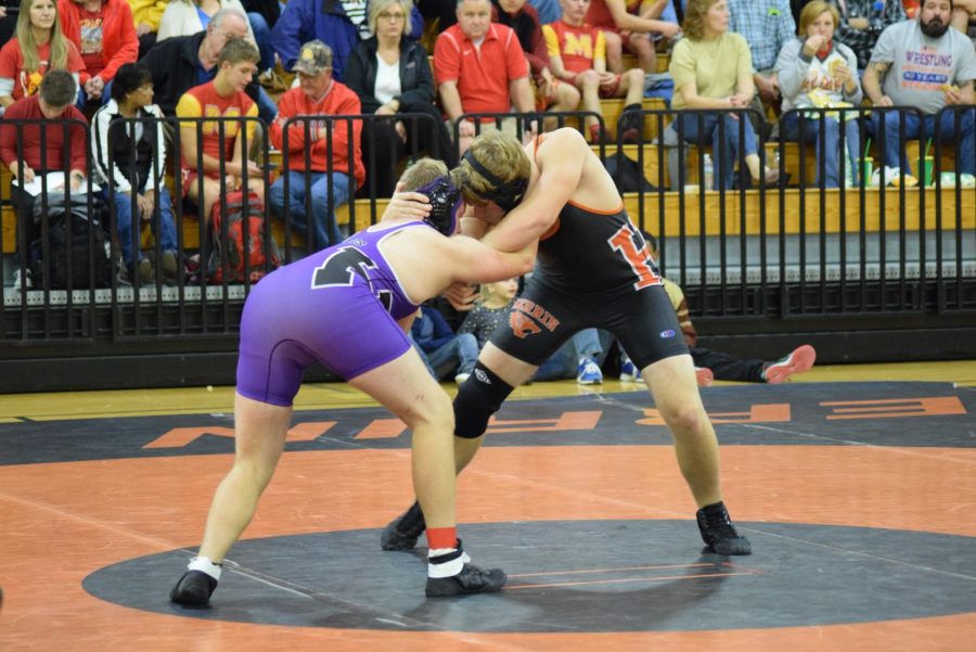 Junior Erik Smith grips onto his opponent during the first round. 