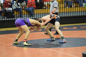 Junior Jace Hahs fights through his opponents grip in attempt for a pin. 