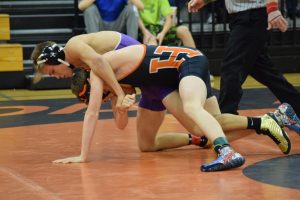 Junior Jace Hahs stands his ground in a tough match against his Harrisburg opponent. 