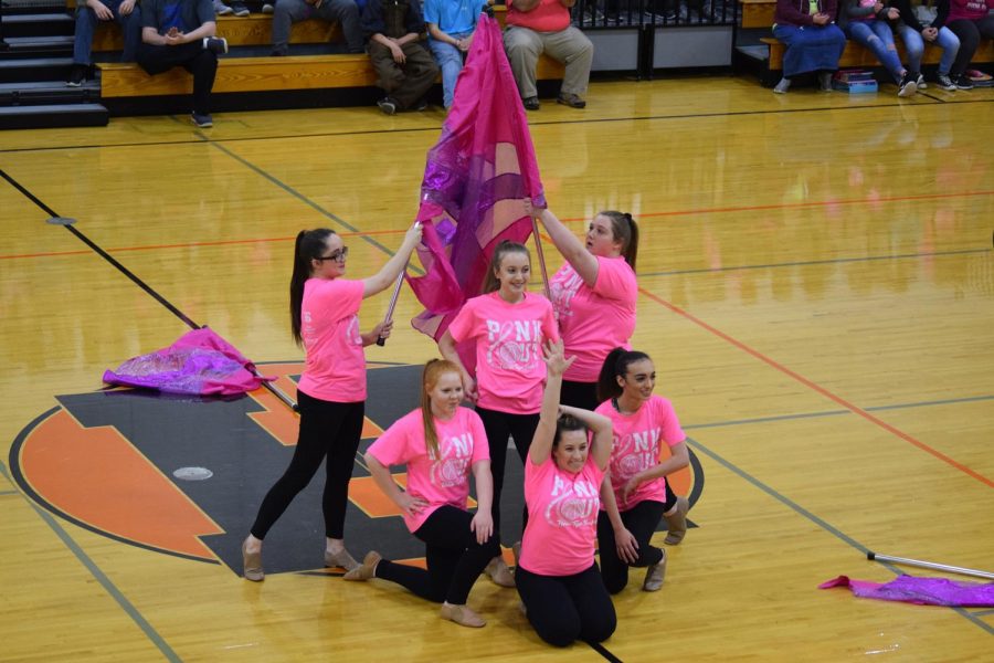 The Herrin High flag team strikes a pose after successfully performing a routine for the Pink Out pep rally.