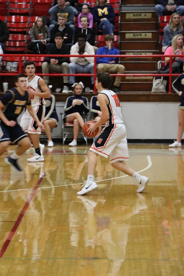 Senior Bronson Nesler dribbles the ball to the other side of the court. 
