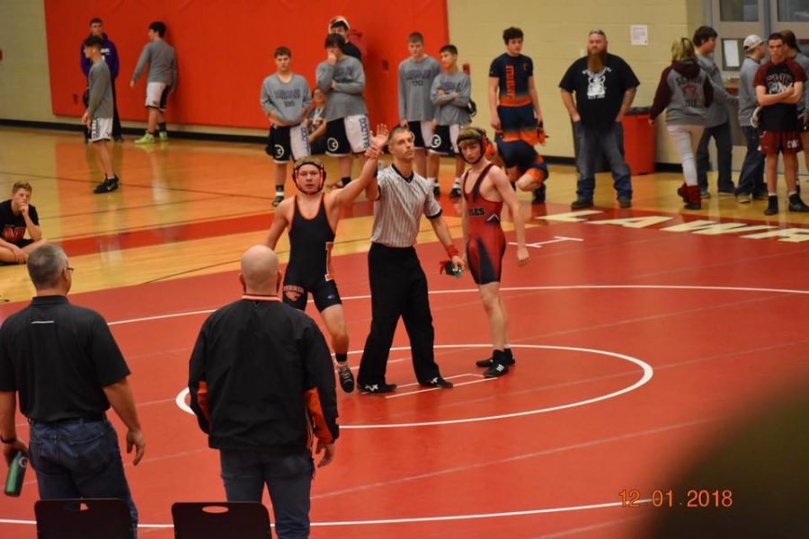 Photo by: Mike McGinnis
Anthony Bowling proudly raising his hand after winning a match. 