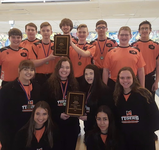 The Boys and Girls Bowling team show off their new hardware.