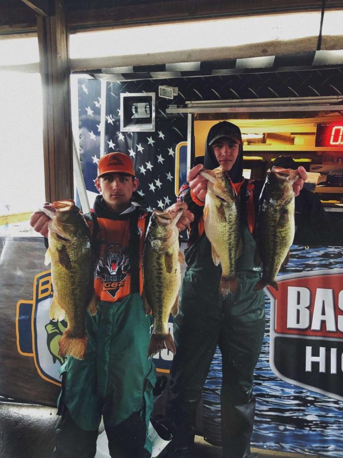 Gunter Gotha (10) and Matthew Brandon (11) show off their catches at the end of a long day on the lake.