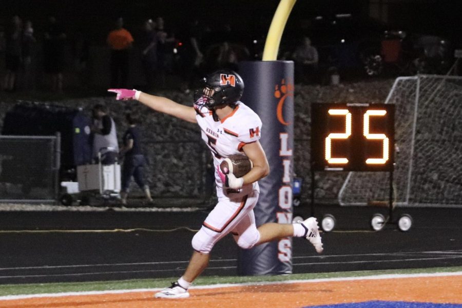 Cameron Damico (12) points to the student section after a phenomenal touchdown against Carterville.