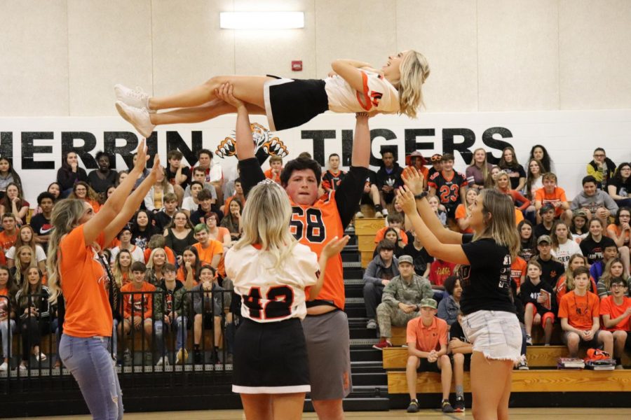 Logan+Cole+%2812%29+proves+his+strength+by+lifting+cheerleader%2C+Lexi+Price+%2812%29+above+his+head.+