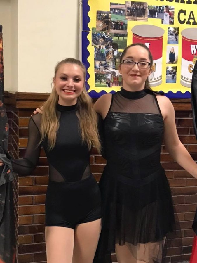 Kylie Watkins (11) and Faith Hacker (11) take a quick photo in the practice room before performing their solo routines at Villa Grove