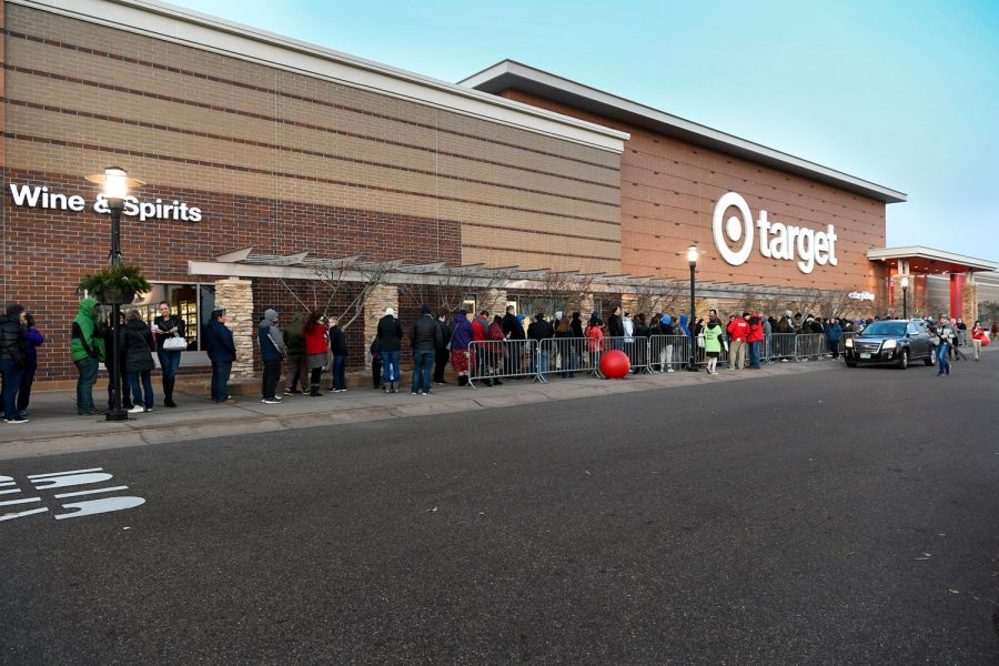 Shoppers line up to get the best deals before the madness begins.