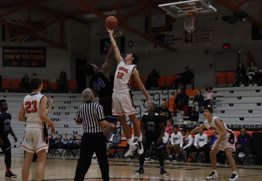 Luke LeQuatte (12) scores for the Tigers in the tip off of the game.