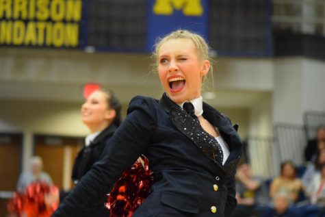 Shanie May (12) winks at the judges while performing a pom routine at the I.D.T.A. Marion Regional Contest.