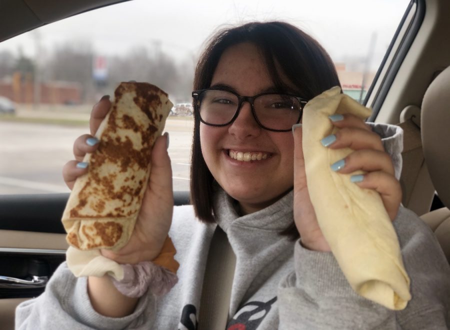 Noelle Cocke (10) holds up a Taco Bell Breakfast Burrito next to a Sonic Breakfast Burrito.