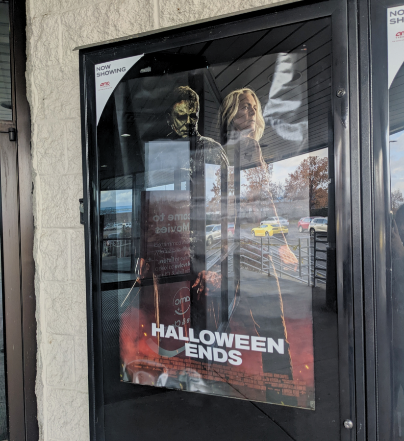 The Halloween Ends movie poster basks in the sunlight.