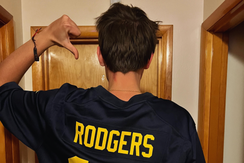 Jarret Coleman (12) gives his Aaron Rodgers jersey a thumbs down.