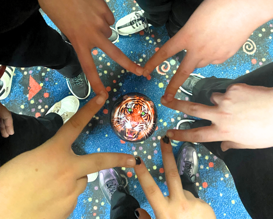 The bowling girls make a star with their fingers to signify a star frame, one strike per person per frame.