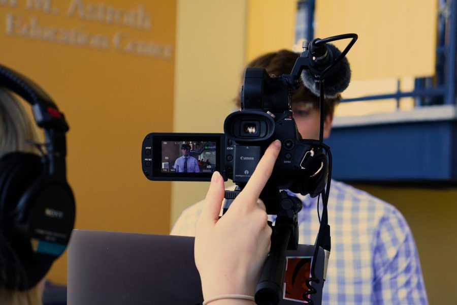 Natalie Coleman films Jacob Hawk for their TV News segment.