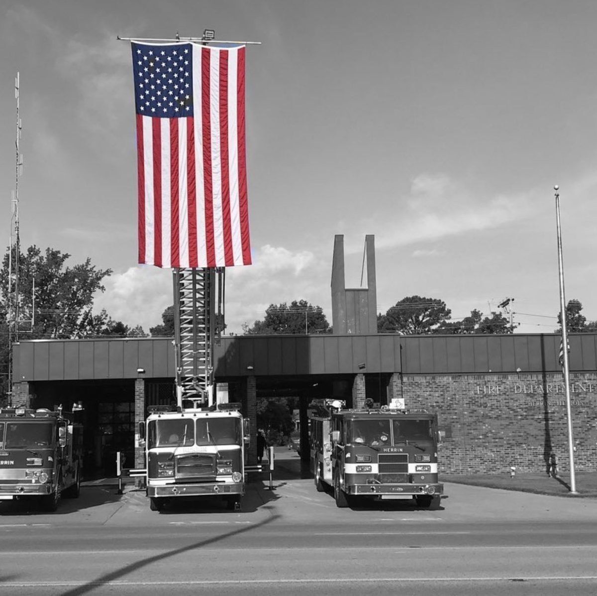 The Herrin Fire Department raises the American flag in tribute and in remembrance of the lives lost to the 9/11 attacks.