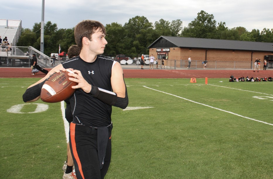 Logan Clough (12) warms up before the first home game of the season.