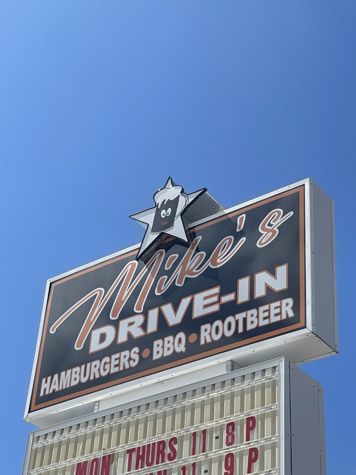 The retro-looking sign of Mikes Drive-In towers over the establishment.