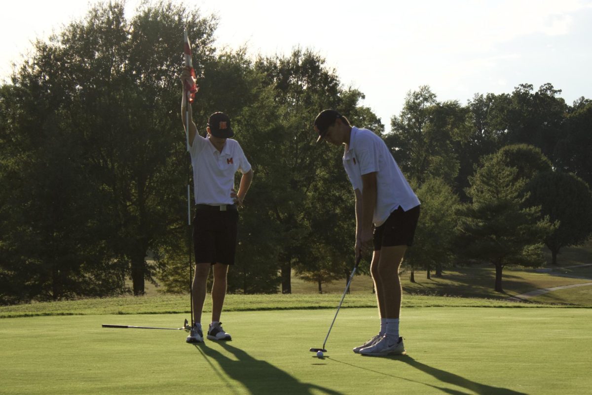 Vance Miles (11) and Carter Mcree (11) focus on the putt.
