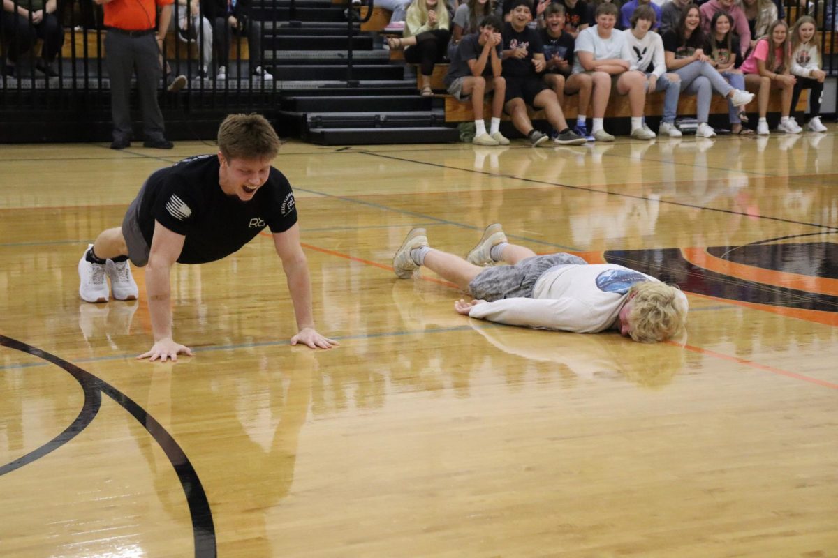 Blue Bishop (12) wins a push-up contest against Luke Smith (12) after a drawn out battle.