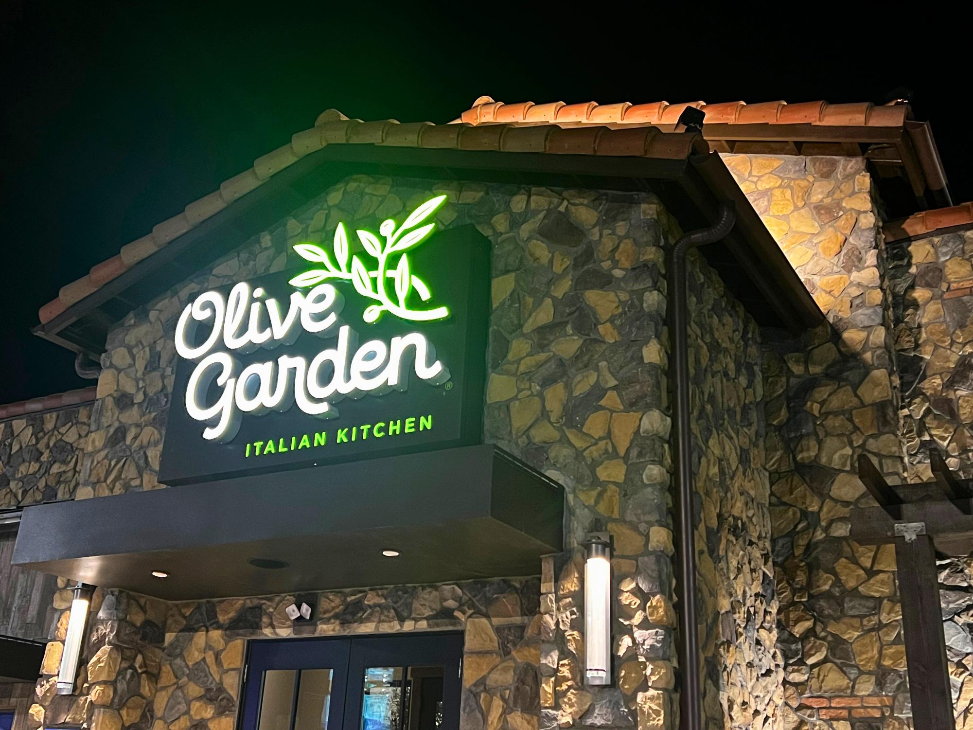The newly built Olive Gardens sign shines in the night.