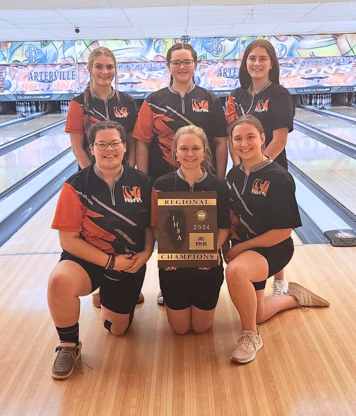 The Herrin Girls Bowling Team proudly holds their Regional Champion plaque after winning the IHSA Carbondale Regional tournament at S.I. Bowl.
