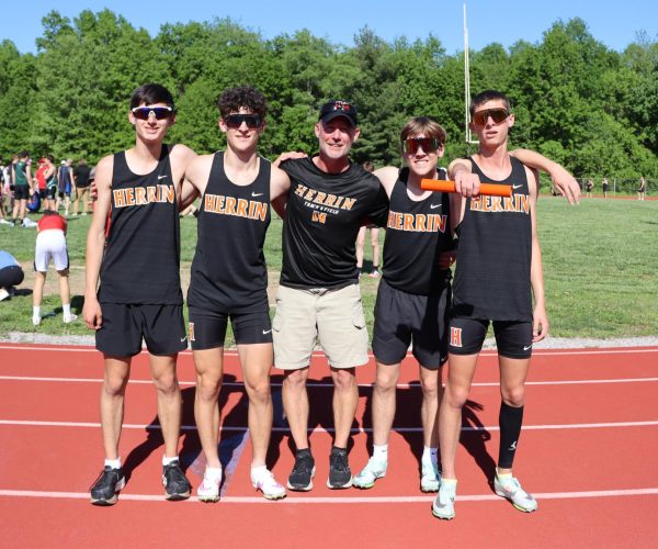 Braden Davis (10), Mason King (10), Coach James Elliott, Nolen Frost (9),
Waylon Hall (11) pose at the end of the race, after beating their coachs record, 34 years later.