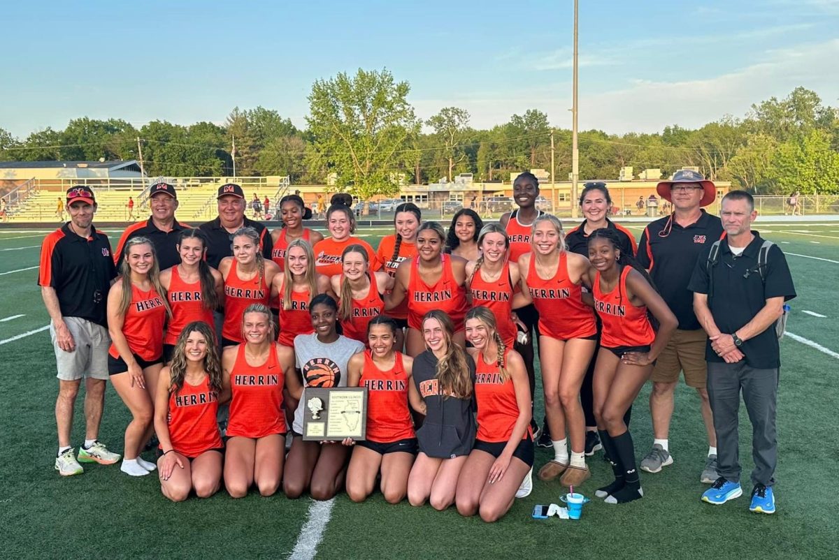 The Lady Tigers Track and Field relish with their plaque, their coaches at their side (Photo acquired from Ms. Apgar).