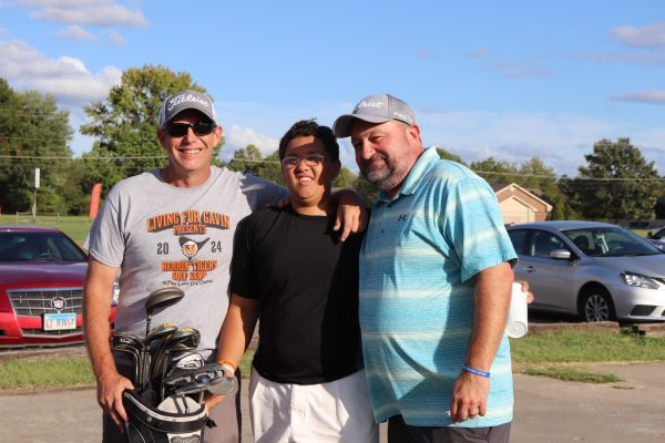 Alex Griffith poses with Coach Priest and Coach Roberts as they present him his reward