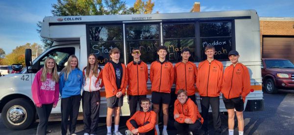 The state-bound cross country team poses by the bus before departing HHS.