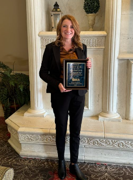 Mrs. Webb standing proud with her award. 