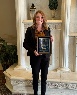 Mrs. Webb standing proud with her award. 