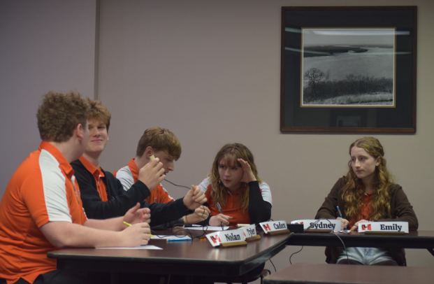 The HHS Varsity Scholastic Bowl Team deliberates their answer at the River To River Conference 
