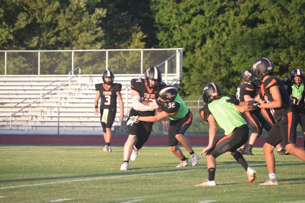 The HHS football team scrimmages during Meet the Teams