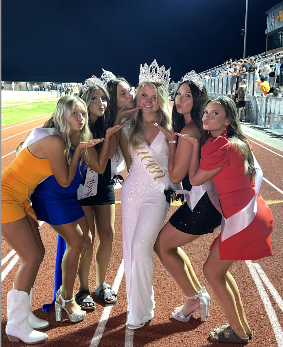 A few senior court members showing their queen love at the football game. 