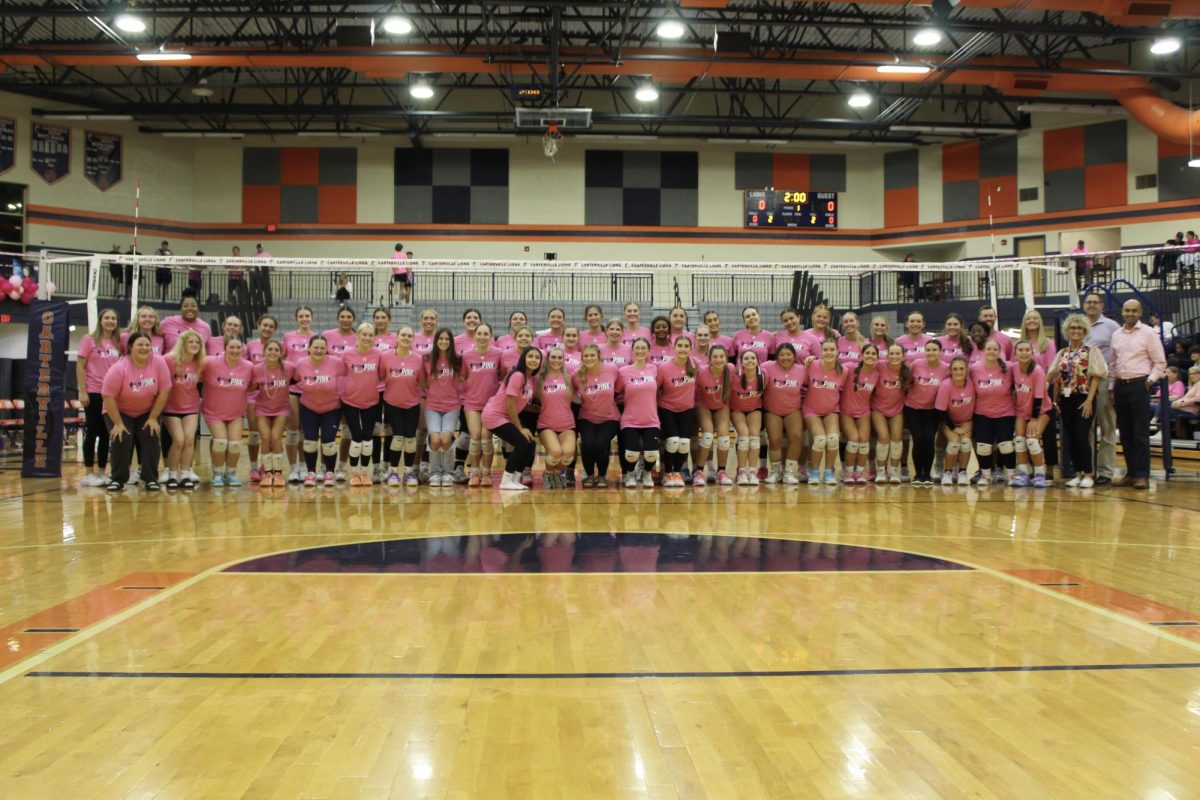 The HHS Volleyball Team gathers during the Pink Out Game in Carterville.