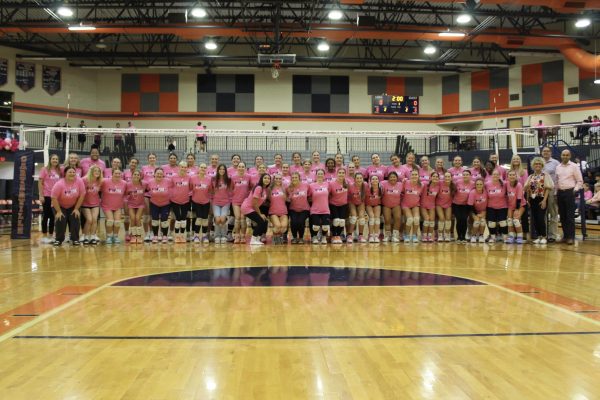 The HHS Volleyball Team gathers during the Pink Out Game in Carterville.