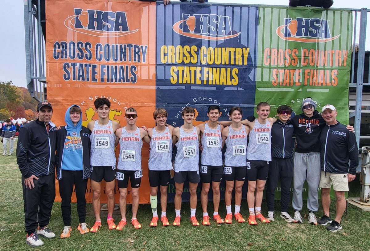 The boys team poses with their coaches after finishing the state meet