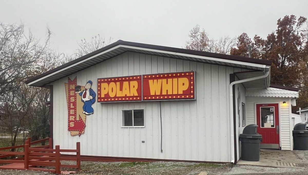The quaint, yet legendary Polar Whip building, decorated in its cozy and retro aesthetic signs
