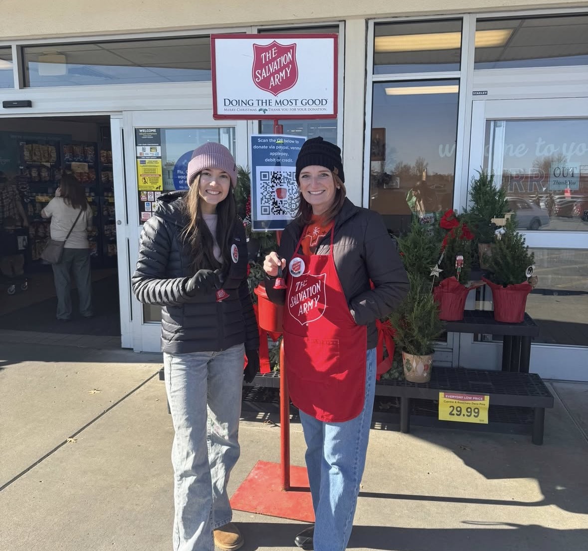 Maddie Martin (12) and Mrs. Webb pose while ringing the bell.
